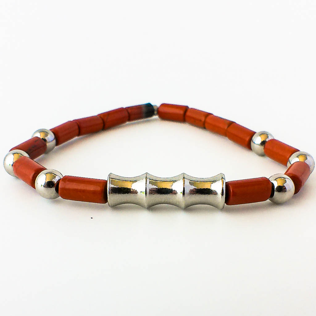 Material: Piedras cilíndricas de Jaspe Rojo de 5 x 9 mm y fornituras de acero inoxidable. Diámetro de la pulsera: 6 cm. Propiedades de la piedra: Vitalidad, fuerza, coraje y determinación. Protección absoluta. Elimina cualquier tipo de dolor. Pensamiento rápido. Transforma las ideas en acción. Concede poder y resistencia. Elemento: Tierra. Estabilidad, seguridad, equilibrio, abundancia y protección. *Las piedras semipreciosas pueden variar ligeramente de tono y forma debido a su origen natural*